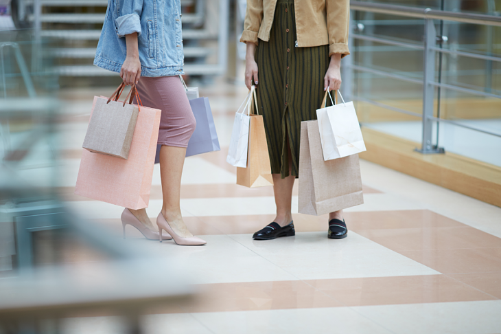 Two ladies holding shopping bags