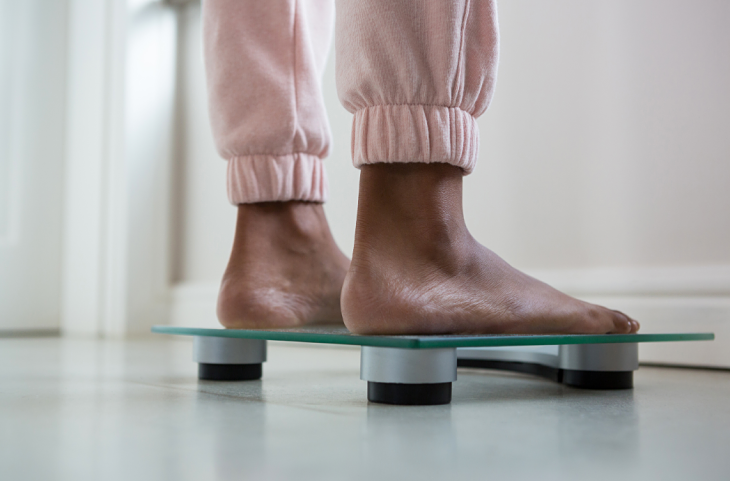 Woman's feet on weight scale
